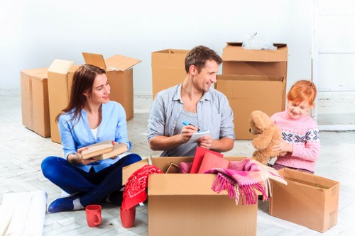 Packed moving boxes and furniture ready for transport in Addiscombe