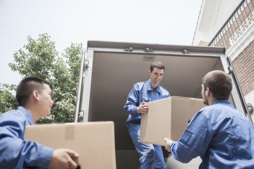 Team member safely lifting boxes during a moving service