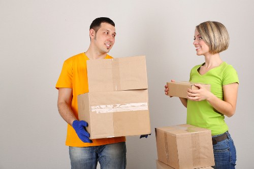 Packed moving boxes and furniture being loaded for removals in Addiscombe