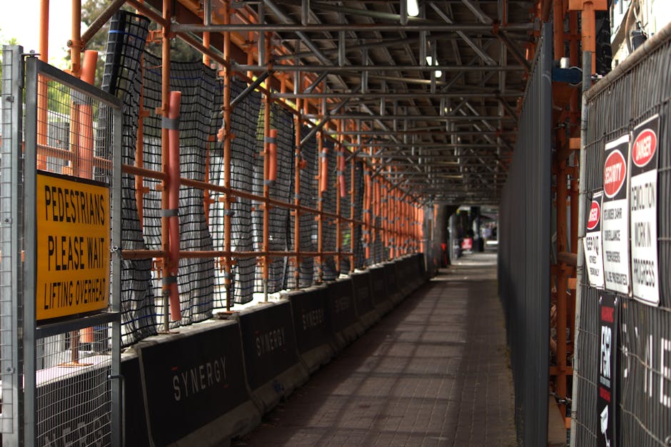 A close-up view of an asphalt parking area with white painted lines designating parking spaces, including a clearly visible yellow wheelchair accessible symbol painted on the ground. The asphalt surface appears slightly textured and weathered. In the background, partially visible are other marked parking spaces and the edge of the pavement. The scene is likely outdoors, with natural lighting highlighting the painted markings and surface details. This setting relates to moving and relocation services by illustrating typical parking provisions used by [COMPANY_NAME], Man with Van Addiscombe, during furniture transport or home relocation activities involving vehicle loading and unloading at property entrances or designated parking zones.